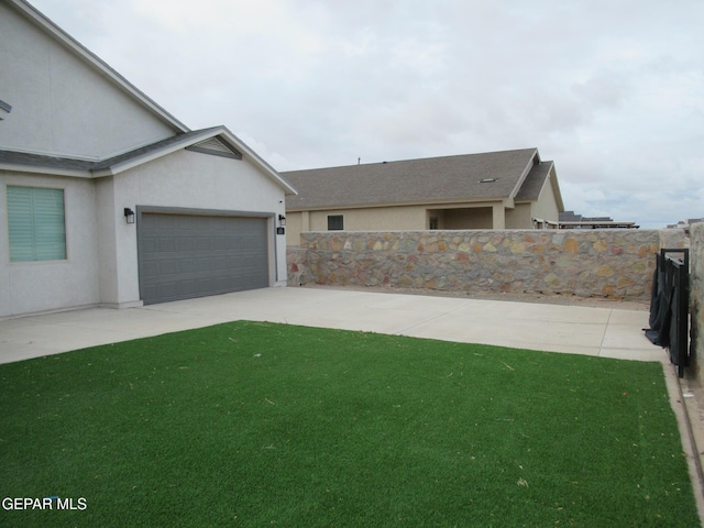 2813 Mike Price Dr, El Paso, TX 79938 - view of front of house with stucco siding, an attached garage, and concrete driveway