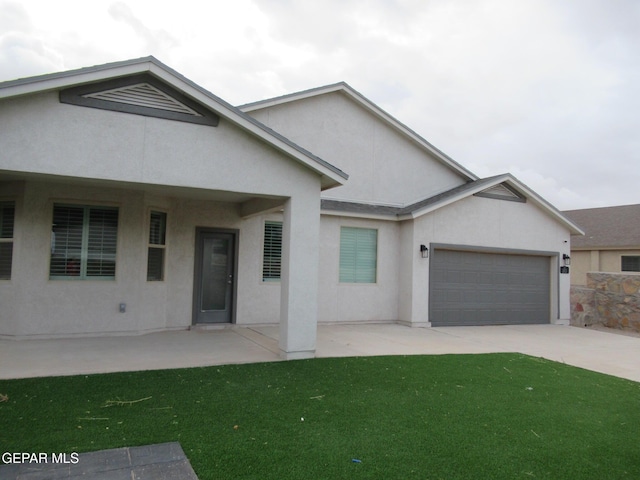 2813 Mike Price Dr, El Paso, TX 79938 - view of front of home featuring stucco siding, an attached garage, concrete driveway, and a front lawn