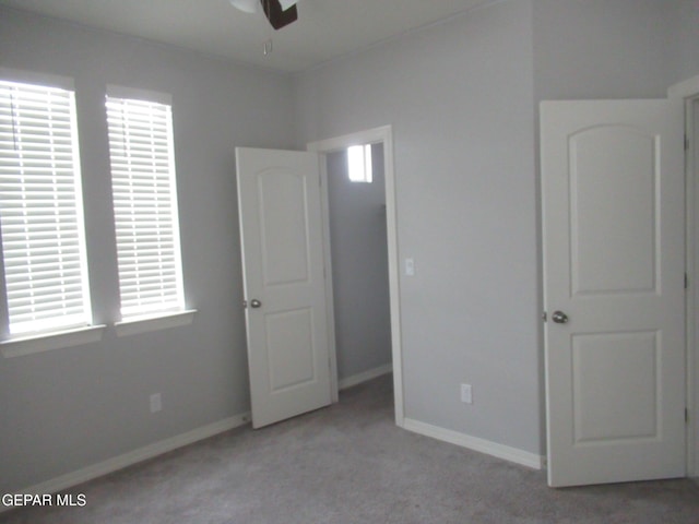 2813 Mike Price Dr, El Paso, TX 79938 - unfurnished bedroom with light carpet and multiple windows