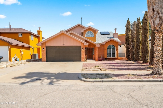 11960 Francis Scobee Dr, El Paso, TX 79936 - traditional-style home featuring a garage, roof mounted solar panels, and concrete driveway