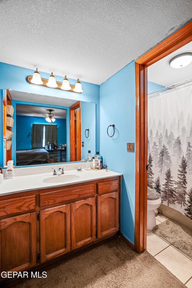 11960 Francis Scobee Dr, El Paso, TX 79936 - full bathroom featuring vanity, ensuite bathroom, a textured ceiling, and curtained shower