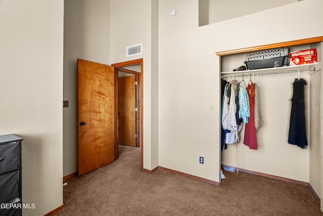 11960 Francis Scobee Dr, El Paso, TX 79936 - unfurnished bedroom featuring carpet flooring, a towering ceiling, and a closet