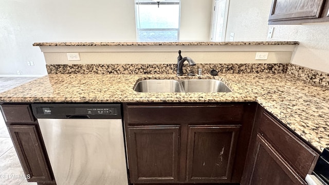 14207 Ranier Point Dr, El Paso, TX 79938 - kitchen featuring stainless steel dishwasher, dark brown cabinetry, and light stone countertops
