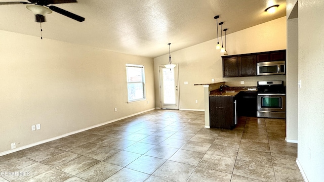 14207 Ranier Point Dr, El Paso, TX 79938 - kitchen with appliances with stainless steel finishes, ceiling fan, lofted ceiling, a textured ceiling, and dark brown cabinets