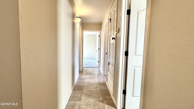 14207 Ranier Point Dr, El Paso, TX 79938 - hall featuring a textured wall, a textured ceiling, and light tile patterned floors