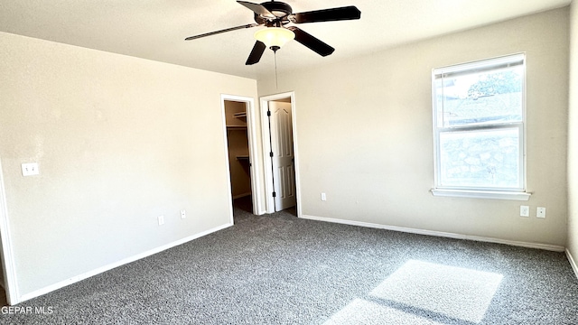 14207 Ranier Point Dr, El Paso, TX 79938 - unfurnished bedroom featuring dark colored carpet, a spacious closet, and ceiling fan