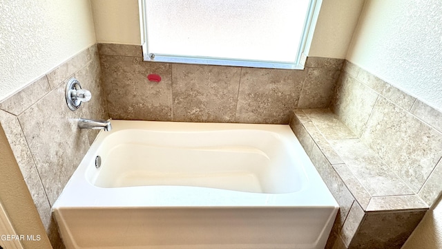 14207 Ranier Point Dr, El Paso, TX 79938 - bathroom with a bath, healthy amount of natural light, and a textured wall