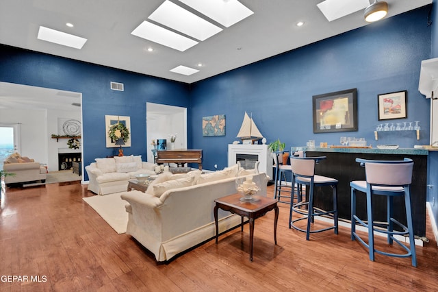 1349 Belvidere St, El Paso, TX 79912 - living room with a fireplace, a high ceiling, a skylight, wood finished floors, and recessed lighting
