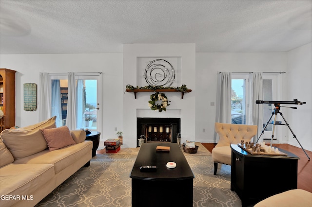 1349 Belvidere St, El Paso, TX 79912 - living room with a textured ceiling, a fireplace, and wood finished floors