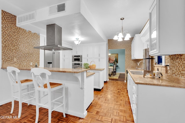 1349 Belvidere St, El Paso, TX 79912 - kitchen featuring ventilation hood, a peninsula, a breakfast bar area, white cabinets, and stainless steel refrigerator with ice dispenser