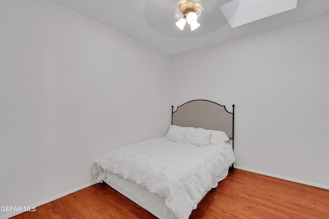 1349 Belvidere St, El Paso, TX 79912 - bedroom with wood finished floors, a skylight, and a ceiling fan
