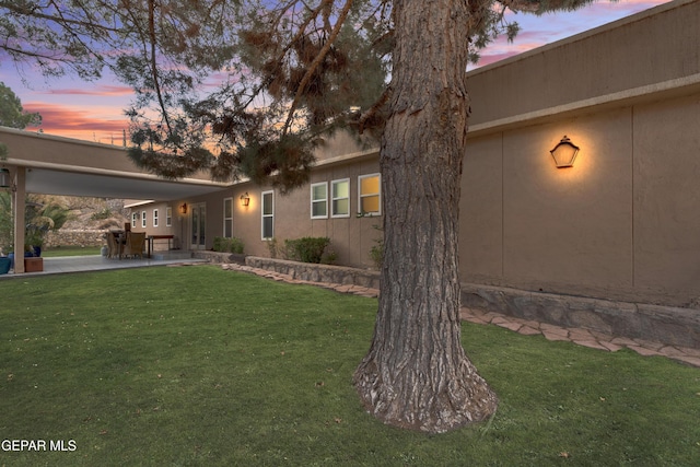 1349 Belvidere St, El Paso, TX 79912 - property exterior at dusk with a yard and a patio area