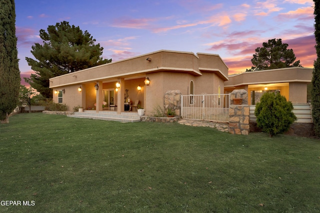 1349 Belvidere St, El Paso, TX 79912 - back of house at dusk featuring stucco siding and a patio