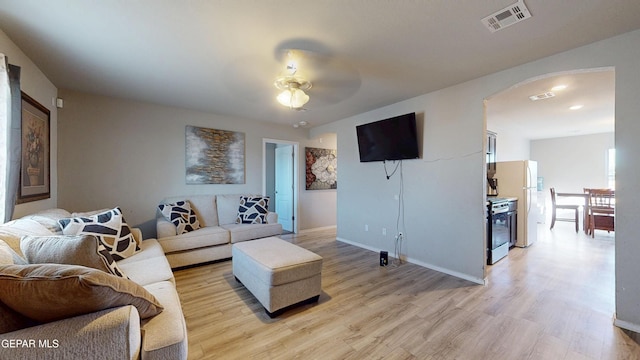 14661 Holly Blue Ave, Horizon City, TX 79928 - living area featuring light wood finished floors, ceiling fan, and arched walkways