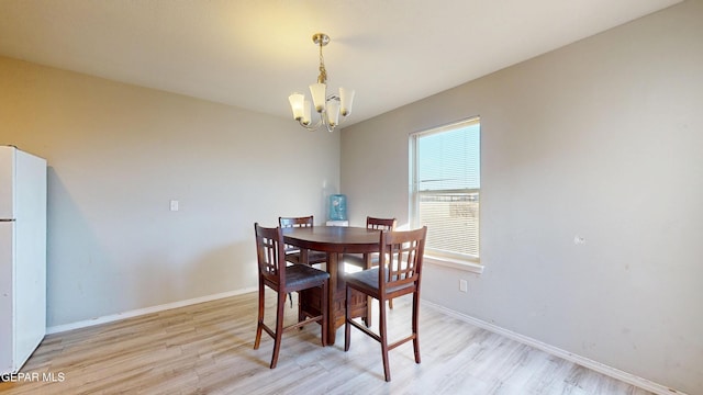 14661 Holly Blue Ave, Horizon City, TX 79928 - dining room featuring light wood-type flooring and a chandelier