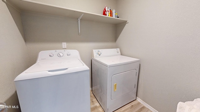 14661 Holly Blue Ave, Horizon City, TX 79928 - laundry room featuring washer and dryer and light wood-style floors