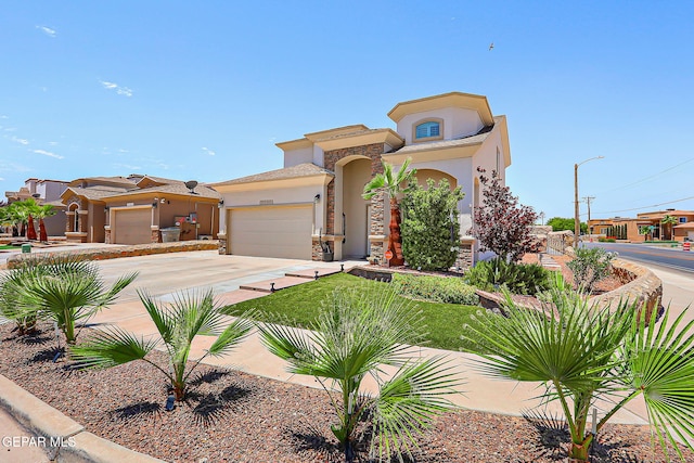 3143 Red Maple, El Paso, TX 79938 - mediterranean / spanish house featuring stucco siding, a garage, driveway, and stone siding