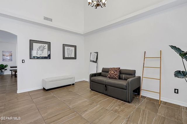 3143 Red Maple, El Paso, TX 79938 - living area with arched walkways, a high ceiling, and a chandelier