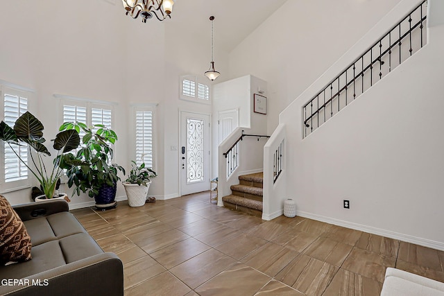 3143 Red Maple, El Paso, TX 79938 - entrance foyer with stairway, a high ceiling, a chandelier, healthy amount of natural light, and tile patterned floors