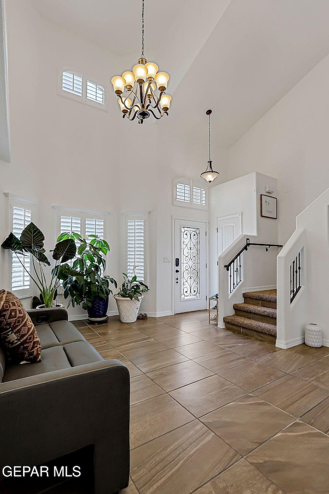 3143 Red Maple, El Paso, TX 79938 - foyer featuring a high ceiling, plenty of natural light, a chandelier, and stairway
