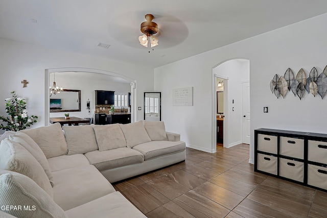 3143 Red Maple, El Paso, TX 79938 - living room with arched walkways, a chandelier, and ceiling fan