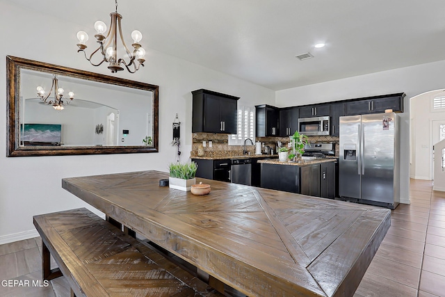 3143 Red Maple, El Paso, TX 79938 - dining space featuring a chandelier and baseboards