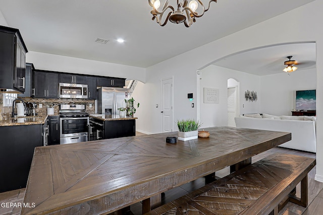 3143 Red Maple, El Paso, TX 79938 - dining space featuring a chandelier, arched walkways, and ceiling fan