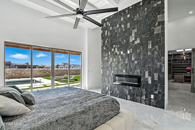 6325 Camino Pinon, El Paso, TX 79932 - bedroom featuring a glass covered fireplace, a high ceiling, marble tiled flooring, and access to exterior