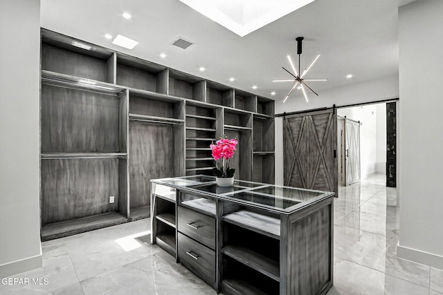 6325 Camino Pinon, El Paso, TX 79932 - spacious closet featuring light marble finish floors and a barn door