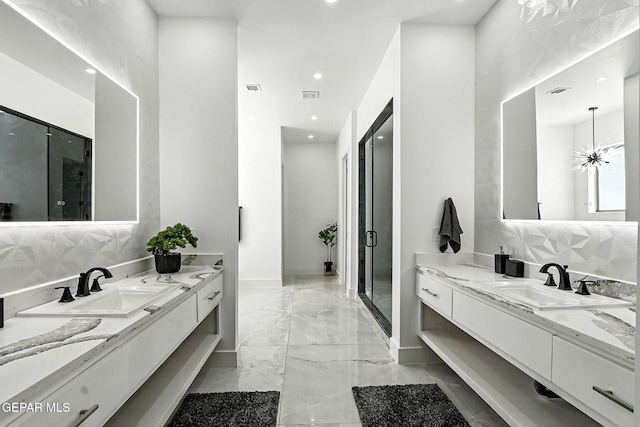 6325 Camino Pinon, El Paso, TX 79932 - bathroom with marble finish flooring, two vanities, recessed lighting, and tasteful backsplash