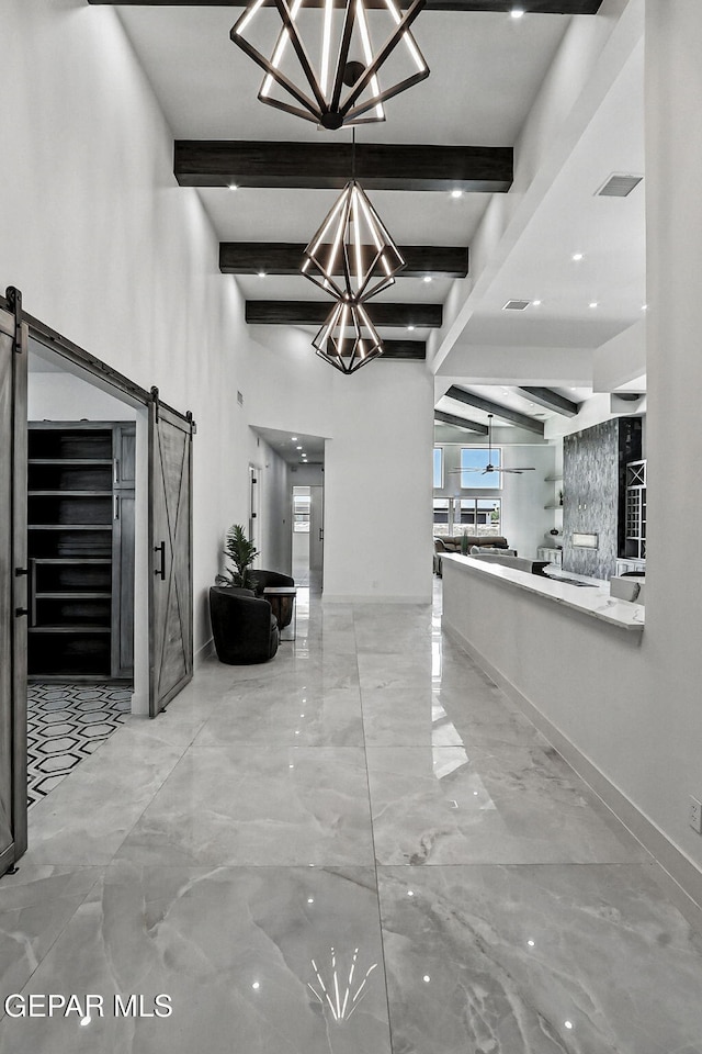 6325 Camino Pinon, El Paso, TX 79932 - hallway with a barn door, a chandelier, beam ceiling, and marble finish flooring