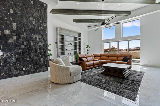 6325 Camino Pinon, El Paso, TX 79932 - living room featuring beam ceiling, a high ceiling, a ceiling fan, and marble finish flooring