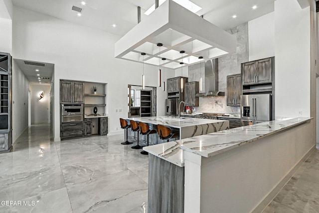 6325 Camino Pinon, El Paso, TX 79932 - kitchen with stainless steel appliances, wall chimney range hood, a high ceiling, coffered ceiling, and a warming drawer