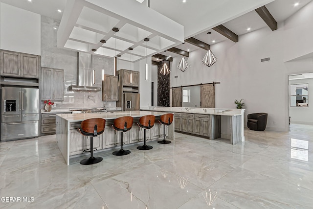 6325 Camino Pinon, El Paso, TX 79932 - kitchen featuring high end fridge, light marble finish floors, beamed ceiling, a large island with sink, and decorative backsplash