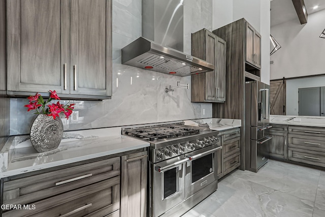 6325 Camino Pinon, El Paso, TX 79932 - kitchen with wall chimney range hood, high quality appliances, tasteful backsplash, light marble finish flooring, and light stone countertops
