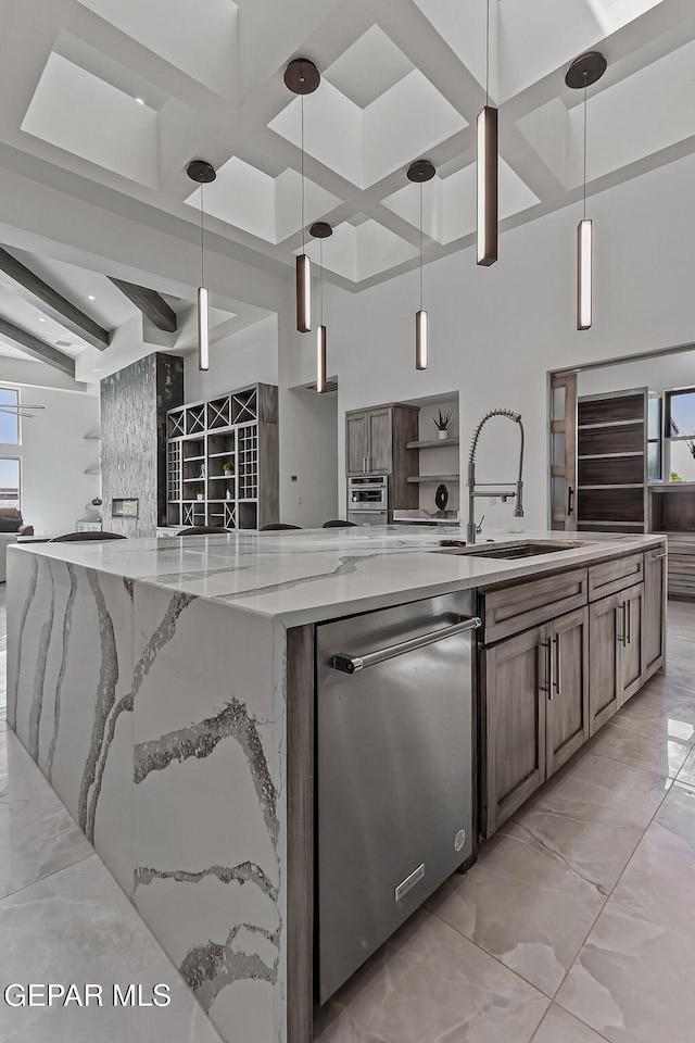6325 Camino Pinon, El Paso, TX 79932 - kitchen featuring stainless steel dishwasher, a spacious island, light marble finish floors, coffered ceiling, and open floor plan