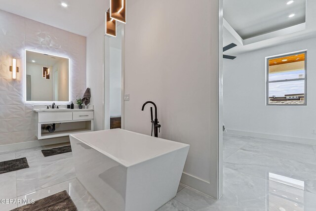 6325 Camino Pinon, El Paso, TX 79932 - bathroom with vanity, a soaking tub, marble look tile flooring, and recessed lighting