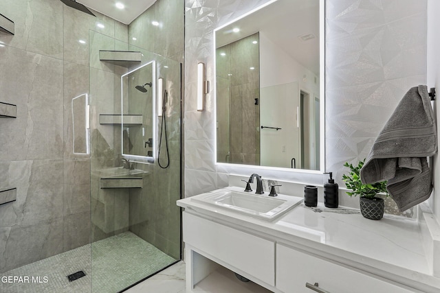6325 Camino Pinon, El Paso, TX 79932 - bathroom featuring a tile shower, vanity, marble finish flooring, and recessed lighting
