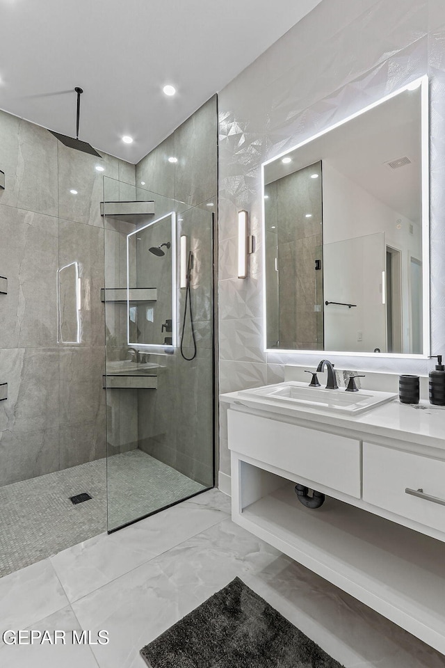 6325 Camino Pinon, El Paso, TX 79932 - full bathroom with vanity, a tile shower, marble finish floors, and recessed lighting