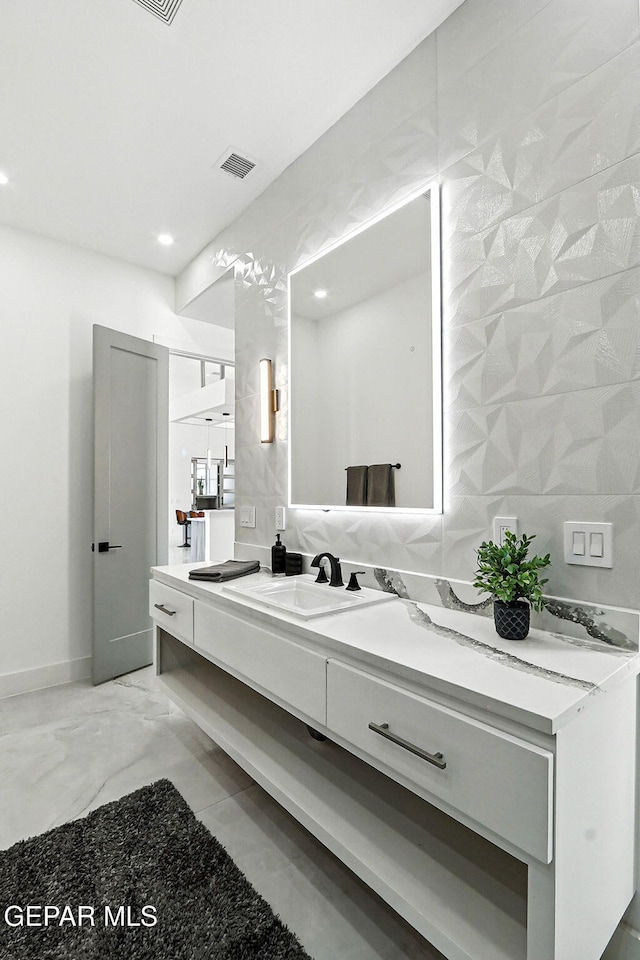 6325 Camino Pinon, El Paso, TX 79932 - bathroom featuring double vanity, marble finish floors, and recessed lighting