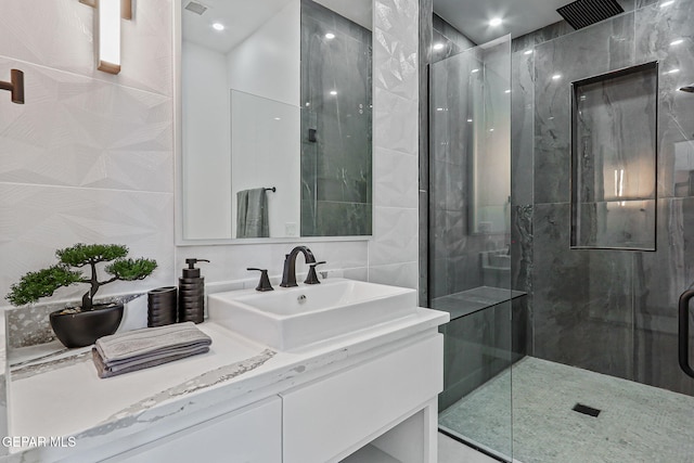 6325 Camino Pinon, El Paso, TX 79932 - full bathroom with a marble finish shower, vanity, and tile walls