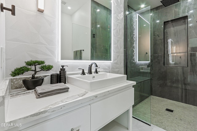 6325 Camino Pinon, El Paso, TX 79932 - bathroom featuring vanity, walk in shower, and tile walls