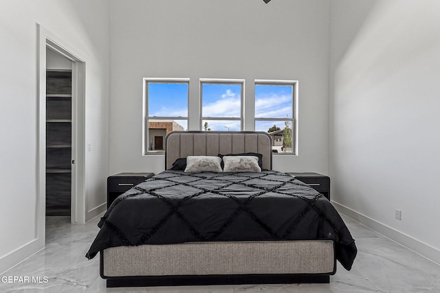 6325 Camino Pinon, El Paso, TX 79932 - bedroom with light marble finish floors and a towering ceiling