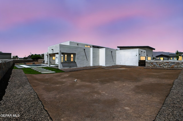 6325 Camino Pinon, El Paso, TX 79932 - back of house at dusk with a patio area and stucco siding