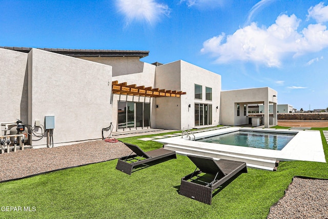 6325 Camino Pinon, El Paso, TX 79932 - rear view of property featuring a pergola, an outdoor pool, stucco siding, a patio area, and a yard