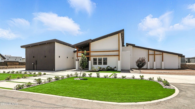 6325 Camino Pinon, El Paso, TX 79932 - contemporary house featuring a front yard and stucco siding