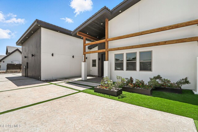 6325 Camino Pinon, El Paso, TX 79932 - view of front of property featuring a balcony, stucco siding, and a patio
