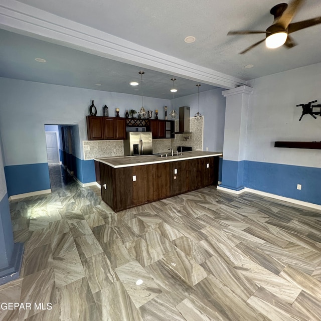 3026 Findley Ave, El Paso, TX 79905 - kitchen with wall chimney exhaust hood, stainless steel fridge, a ceiling fan, tasteful backsplash, and open floor plan