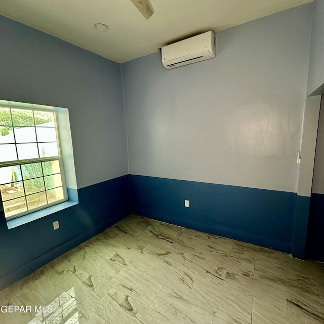 3026 Findley Ave, El Paso, TX 79905 - empty room featuring a wall mounted air conditioner and marble look tiles
