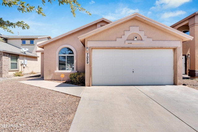 7029 Copper Canyon Dr, El Paso, TX 79934 - mediterranean / spanish home featuring concrete driveway, a garage, and stucco siding